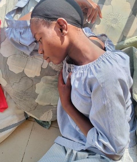 Moreen resting, unwell, while she waits for the surgery she needs